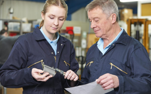 Man and woman workers looking at measurement data