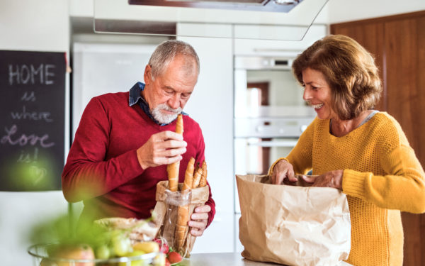 Older woman and man looking at a bag of crusty breads
